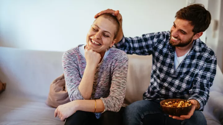 Man and woman with cancer sitting on couch
