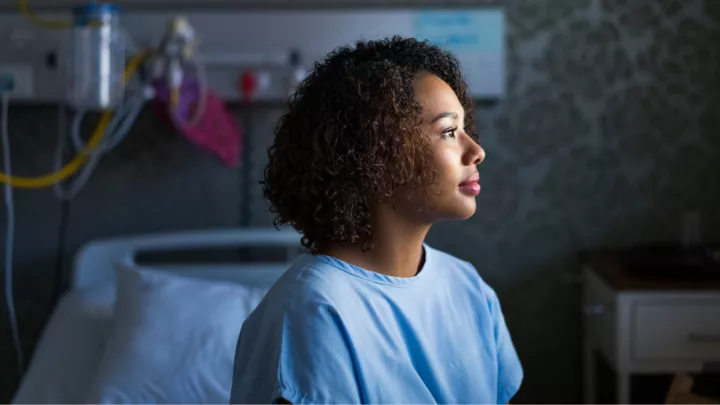 Woman sitting in a hospital gown