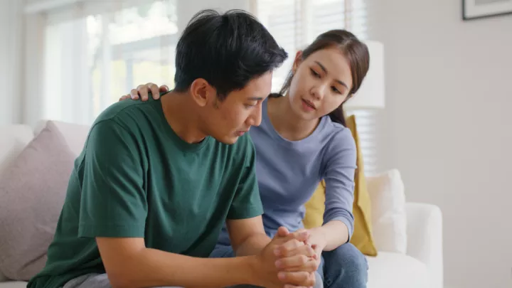 Man and woman sitting on couch