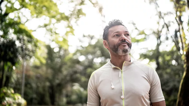A middle-aged man walking in the woods